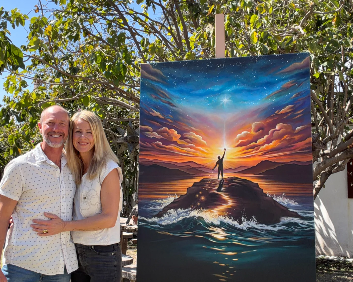 Grant Pecoff and Stephanie Clair standing beside a completed Gemini painting