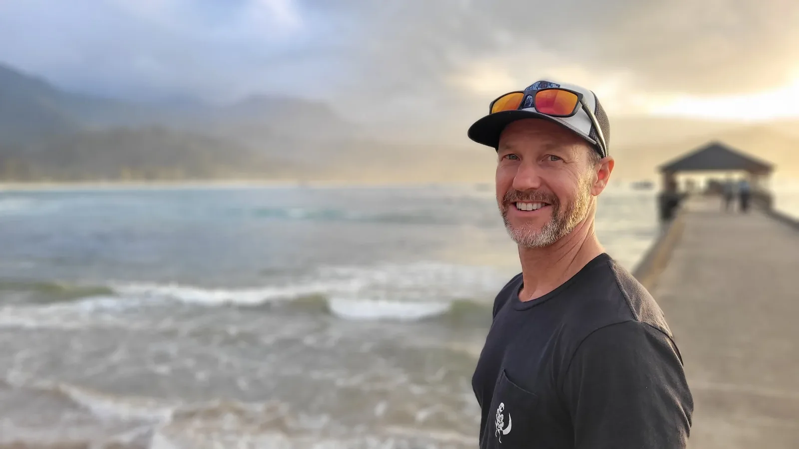 Grant Pecoff standing by the ocean