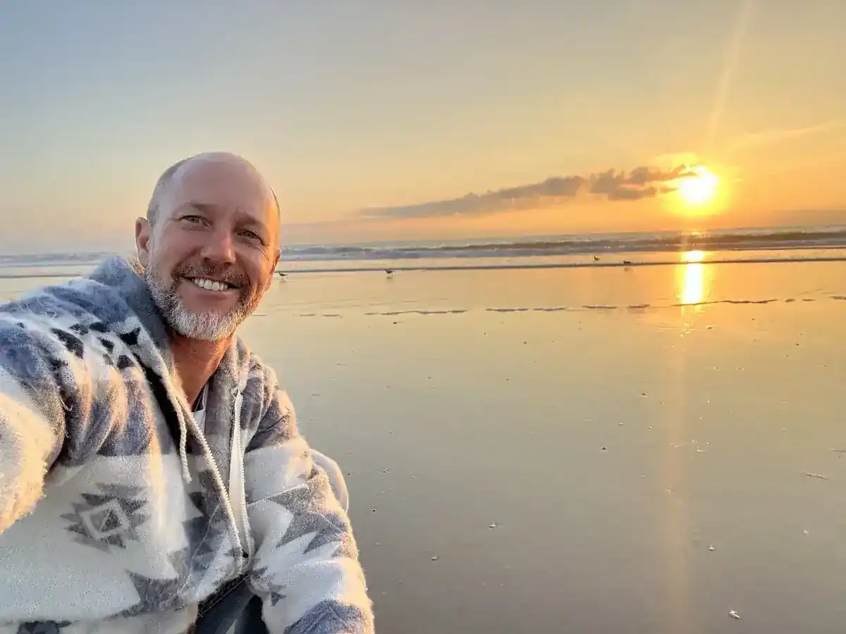 Grant Pecoff at the beach at sunset