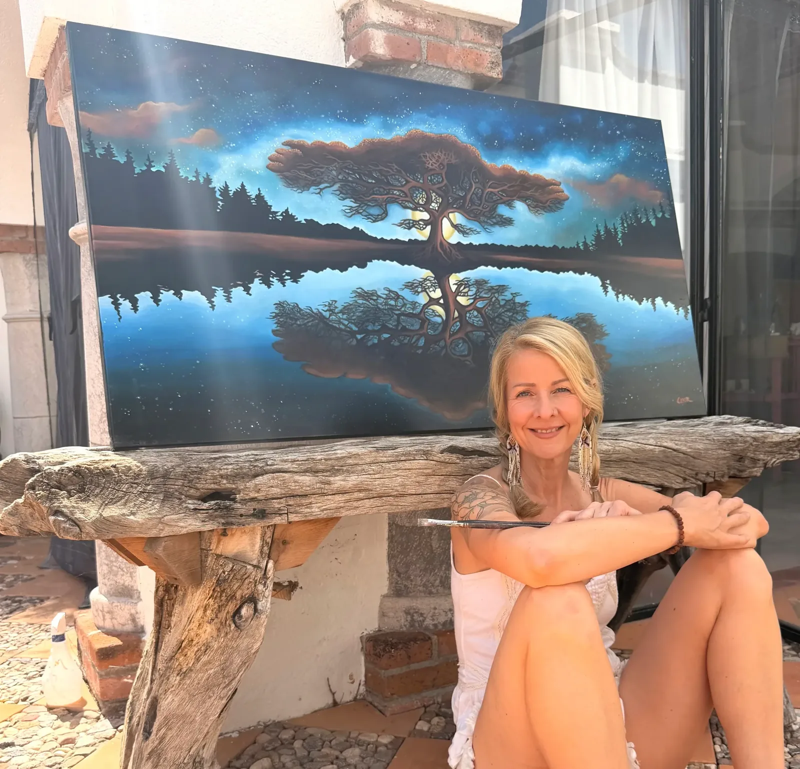 Stephanie Clair with one of her paintings